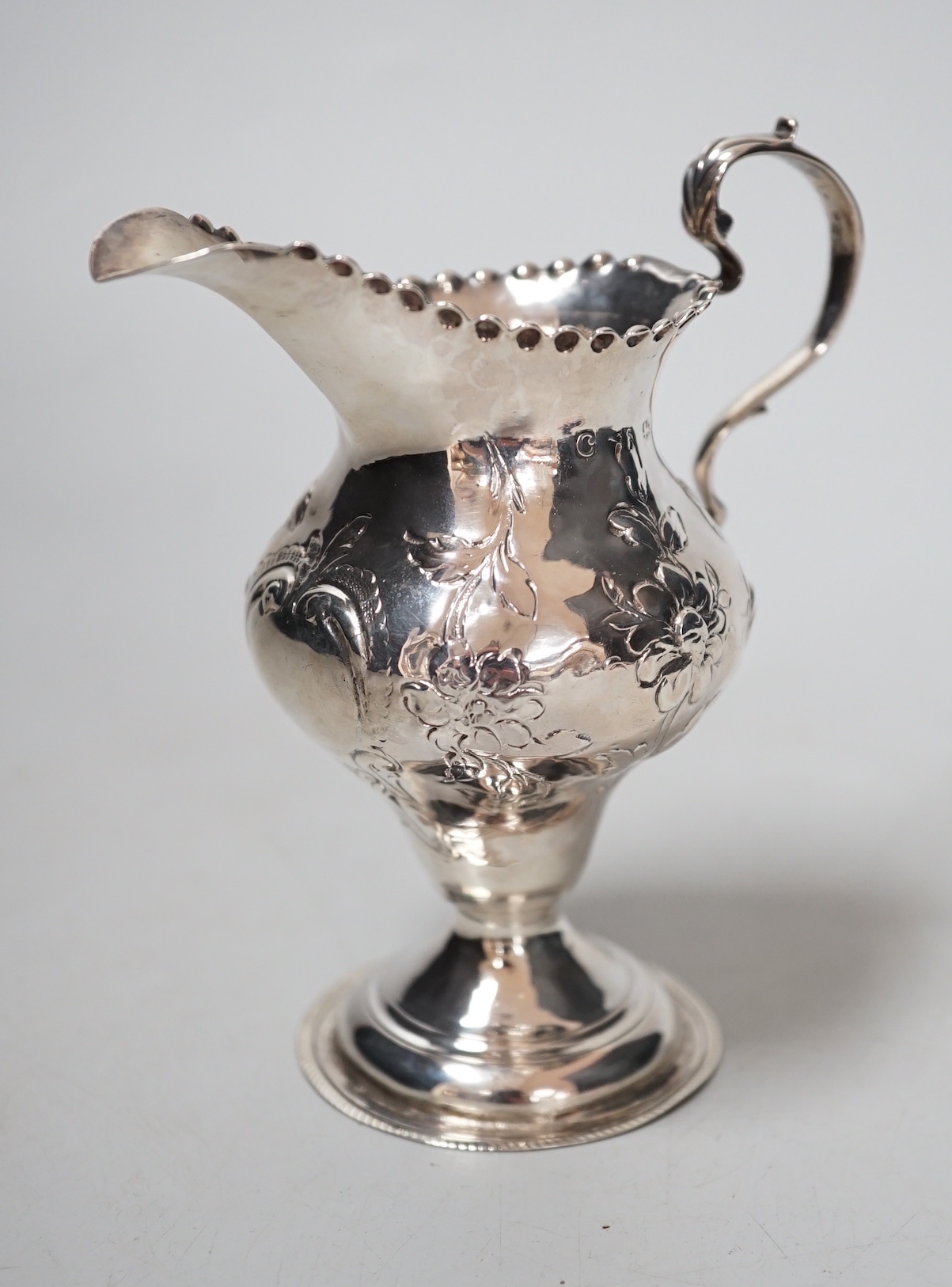 A George III silver inverted pear shaped cream jug, maker H?, London, 11.2cm, 75 grams.